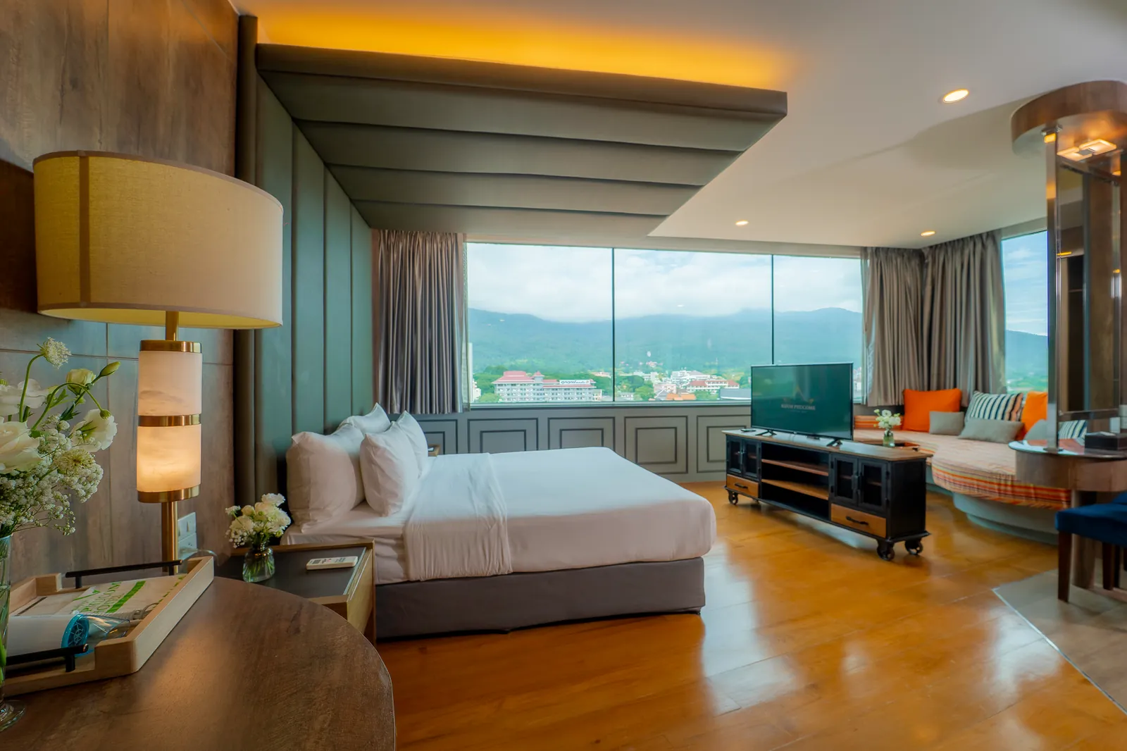 Executive suite at Khum Phucome Hotel Chiang Mai, with floor-to-ceiling windows looking out to the mountains