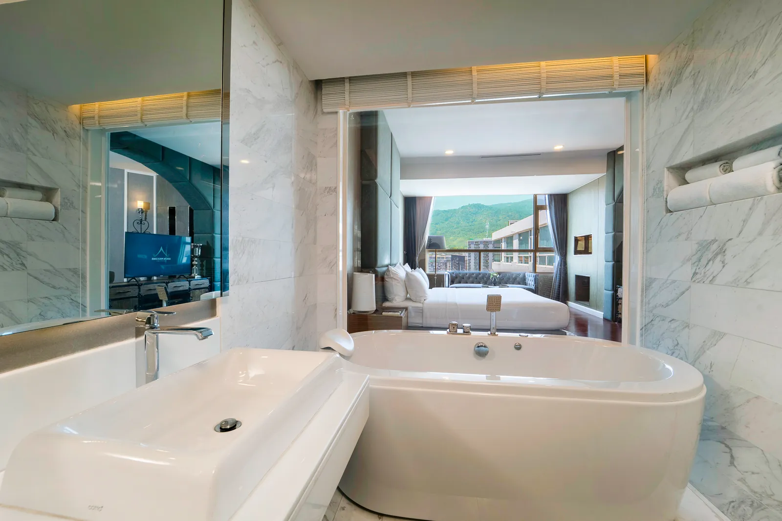 Marble bathroom in an executive suite at Khum Phucome Hotel Chiang Mai, with a jacuzzi tub opening onto the bedroom
